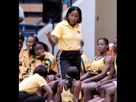 In this file photo from November 2005, Connie Francis (standing) talks tactics during one of her coaching sessions with the senior national netball team.