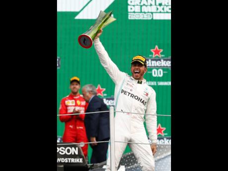 Credit: Eduardo Verdugo Mercedes Formula One driver Lewis Hamilton, of Britain, celebrates after winning the Mexico Grand Prix at the Hermanos Rodriguez racetrack in Mexico City yesterday.