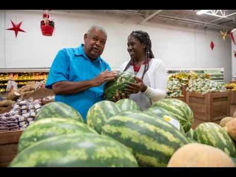 Credit: Gladstone Taylor Lenworth Fulton (left), president of the Jamaica Agricultural Society, checks out locally produced watermelons with Monique Gibbs, chief technical director in the Ministry of Industry, Commerce, Agriculture and Fisheries, during the launch of Eat Jamaican Month at MegaMart in St Andrew on Friday.