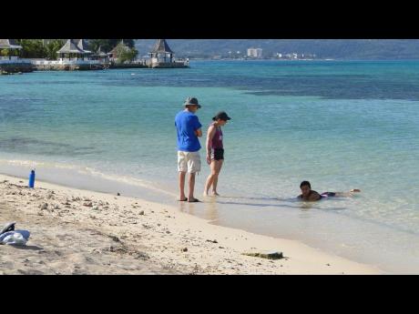 Visitors chilling on Dead End Buccaneer Beach in Montego Bay recently.