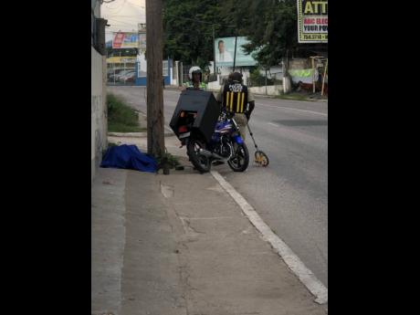 Policemen secure the crash scene which had deadly consequence for bearer FitzRoy Grant. 