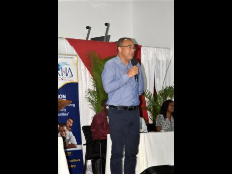 Health Minister Dr Christopher Tufton addressing a town hall meeting in Negril, Westmoreland, on Thursday. Dengue was among the issues discussed. 
