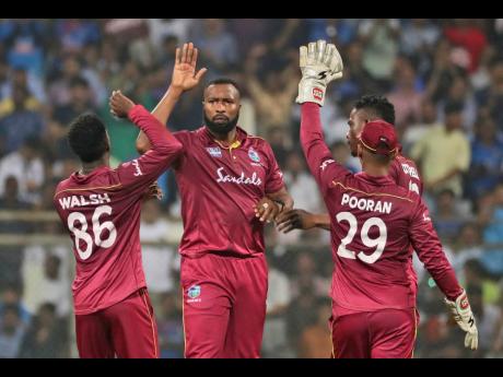 Windies’ players celebrate the dismissal of India’s Rishabh Pant during their third Twenty20 international cricket match in Mumbai, India, on Wednesday.
