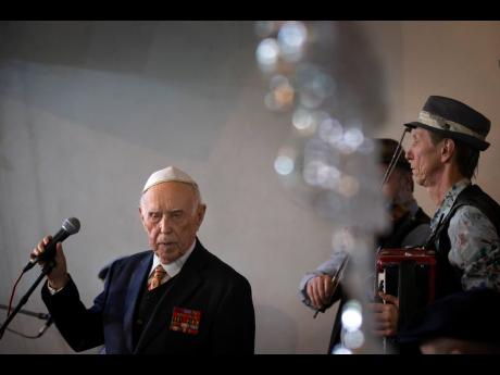 Holocaust survivor and WWII veteran Mikhail Spectr, 86, pauses as he speaks during the annual Hanukkah Menorah Lighting Ceremony in Moscow, Russia, Sunday. Spectr was taken to Jewry in 1941 at the age of 8 when Nazi soldiers arrived at his village in Ukraine Soviet republic. Mikhail Spectr had been kept at ghetto in Transnistria, territory between Dniester and Southern Bug, occupied by the Nazi and its allies from 1941 and 1944.