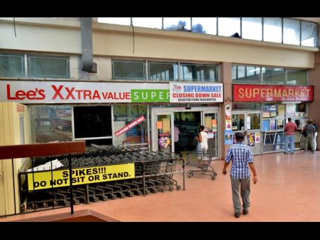 Customers make their way into Xxtra Supermarket in the Red Hills Mall yesterday ahead of its closure this weekend.