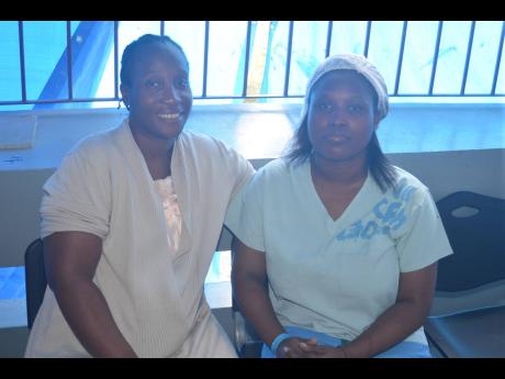 Credit: Photo by Christopher Thomas Keisha Miller-Thomas (left), mother of newborn Daniel Duval Thomas, is all smiles as she poses with Donna Hewitt-Channer, acting ward manager of the delivery suite at the Cornwall Regional Hospital. Little Daniel, who was born prematurely at 28 weeks, is currently in an incubator to monitor his growth and development.