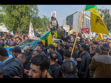 Credit: The Associated Press Mourners march during the funeral of Iran’s top general Qassem Soleimani, 62, Abu Mahdi al-Muhandis, deputy commander of Iran-backed militias in Iraq known as the Popular Mobilization Forces and fellow militant leaders, in Baghdad, Iraq, Saturday, January 4, 2020.