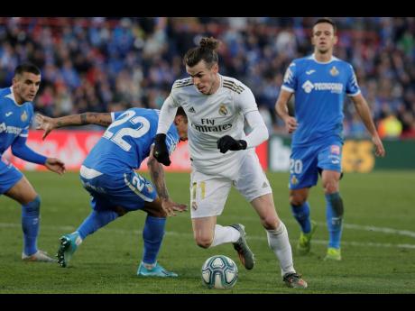 Credit: AP
Real Madrid’s Gareth Bale (centre) dribbles through the defence during a Spanish La Liga match between Getafe and Real Madrid at the Coliseum Alfonso Pérez stadium in Getafe, Spain, yesterday. Real Madrid won 3-0.