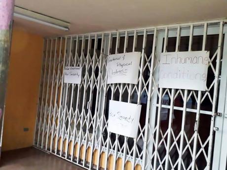 Placards are posted at the entrance to the St James Parish Library yesterday. 