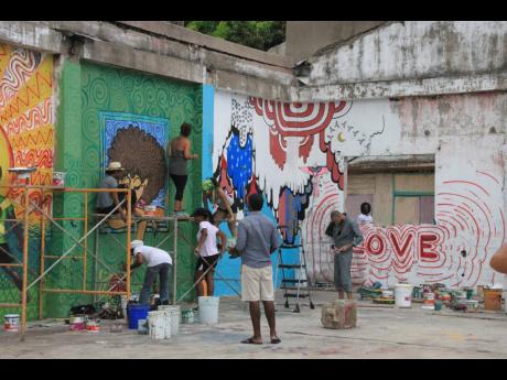 Colours of inspiration and brush strokes of renewed hope .... volunteers of Paint Jamaica bring walls in Fleet Street, downtown Kingston to life.