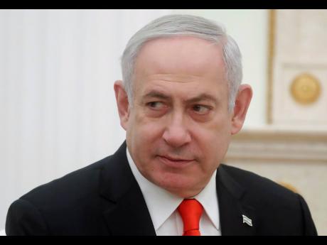 Israeli Prime Minister Benjamin Netanyahu listens to Russian President Vladimir Putin during their meeting in the Kremlin in Moscow, Russia, Thursday, Jan. 30, 2020. Netanyahu visited Moscow to discuss the U.S. Mideast peace plan with Putin and take an Israeli woman who had been jailed in Russia back home. (Maxim Shemetov/Pool Photo via AP)