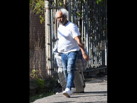 Ivanhoe Spencer-Chen pulls along his luggage shortly before leaving Harman Barracks, where he and 16 other deportees were processed last Tuesday.