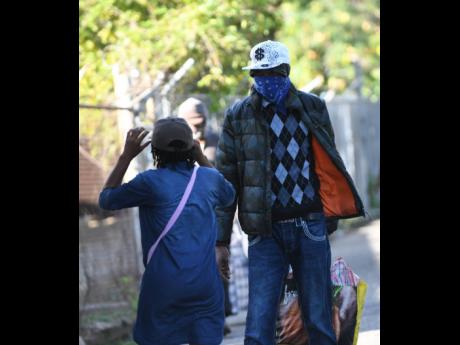 A deportee is met by a relative at Harman Barracks in Kingston last Tuesday. He was one of 17 people sent back on a charter flight from the United Kingdom. 