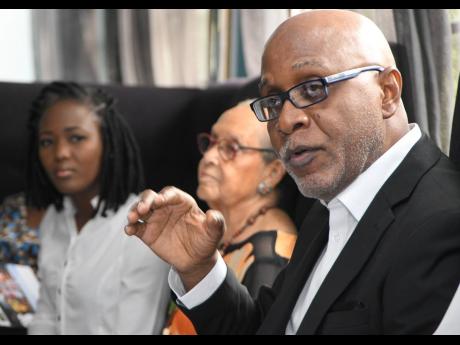 Credit: Rudolph Brown Pulse Investments Chairman Kingsley Cooper addresses shareholders at the company’s annual general meeting on Tuesday, February 18, 2020, at Villa Ronai, Stony Hill, St Andrew. Co-Managing Director Safia Cooper is at left and Director Lois Sherwood at centre.