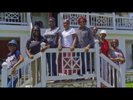 The women of Bonny Gate pose on the steps of the historic Rio Nuevo Great House. From Left: Ena Sinclair; Shakira Deer from the Ministry of Culture, Gender, Entertainment and Sport; Ruby Lyn-Bennett; Norma Nugent; Shirley Vernon; Hermine Henry; Juliet Smith; Rose Anna Smith.
