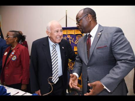 Credit: Rudolph Brown/Photographer US Ambassador Donald Tapia (left) has a light moment with Robert Lawrence, president of the Lions Club of Kingston, at a luncheon meeting at The Jamaica Pegasus in New Kingston on Wednesday.