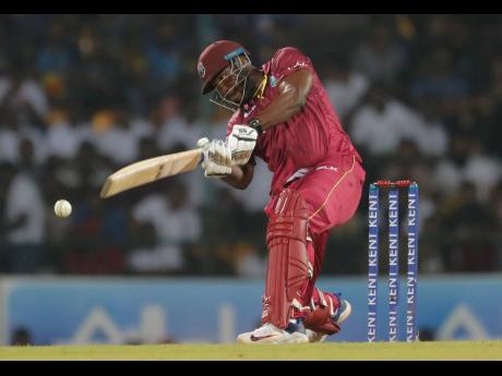 West Indies’ batsman André Russell plays a shot during their second Twenty20 cricket match with Sri Lanka in Pallekele, Sri Lanka, yesterday. West Indies won by three wickets.