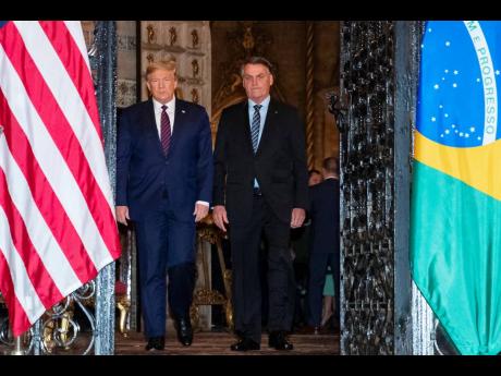 Credit: The Associated Press President Donald Trump arrives before a dinner with Brazilian President Jair Bolsonaro at Mar-a-Lago on Saturday, March 7.