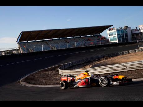 In this Wednesday, March 4, 2020, file image, F1 driver Max Verstappen of The Netherlands drives his car through one of the two banked corners during a test and official presentation of the renovated F1 track in the beachside resort of Zandvoort, western Netherlands. 