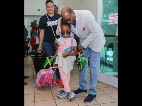 
Minister of Tourism Edmund Bartlett greets passengers arriving at the Sangster International Airport during an inaugural flight.