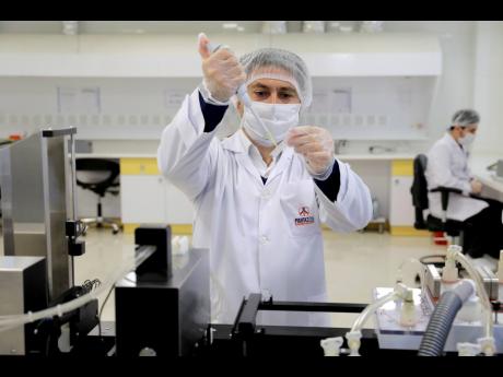 A scientist works in a lab on coronavirus testing kits just outside Tehran, Iran last week.