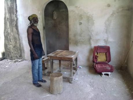 The owner of the house shows The Gleaner where the men were playing a game of dominoes prior to the shooting on Sunday.