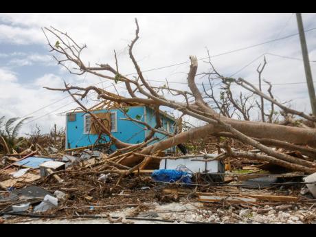 In this September 19, 2019 photo, buildings in Marsh Harbor on the island of Abaco in The Bahamas are devastated by the effects of Hurricane Dorian, an extreme hurricane, more of which are expected in the Caribbean, courtesy of a changing climate. 