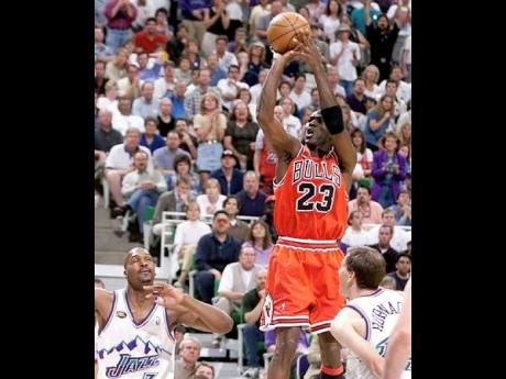 Michael Jordan  making the final shot that won the Chicago Bulls their sixth NBA Championship trophy. It was also the last game he played with the Bulls.