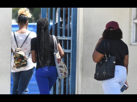Employees of Alorica call centre enter the Portmore Informatics Park to undergo testing for COVID-19  after two co-workers were confirmed of being infected with the novel coronavirus.