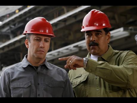 Credit: AP In this May 19, 2018 file photo, Venezuela’s President Nicolas Maduro, right, and Vice-President Tareck El Aissami tour La Rinconada baseball stadium that is under construction on the outskirts of Caracas, Venezuela.