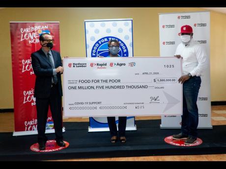 Joe Bogdanovich (left), chairman, Caribbean Love Now, and Marcus Richards (right), managing director, Hardware & Lumber, make the symbolic presentation of J$1.5 million to Kivette Silvera, director, Food For The Poor. The charity reports an uptick in the number of people it serves following job losses across the country. Hardware & Lumber will also donate one per cent of its online sales for three months.  