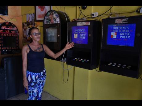 Audrey Blidgen, operator of Sun Rise Pub on Penwood Road in Waterhouse, explains how social-distancing rules will complicate the use of slot machines at her saloon. Bars were ordered closed by the Government on March 18 to help curb the spread of the new coronavirus.