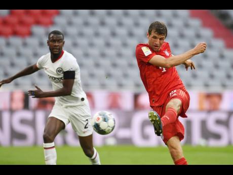 
Bayern Munich’s Thomas Muller scores his side’s second goal during their German Bundesliga match against Eintracht Frankfurt in Munich, Germany, yesterday.
