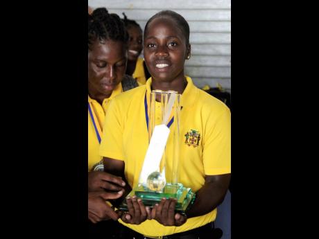All-rounder Shanel Daley with the winning trophy after Jamaica’s victorious women’s cricket team arrived home  from the WICB’s Women’s League tournament in 2011.