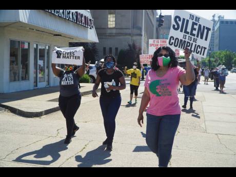 In this Saturday, June 6, 2020 photo provided by ‘The Record’, black Catholics walk from the federal courthouse  in downtown Louisville, Kentucky, to 12th and Broadway, in the ‘Black Catholics Unite: Stand For Justice’ march which was organised by 
