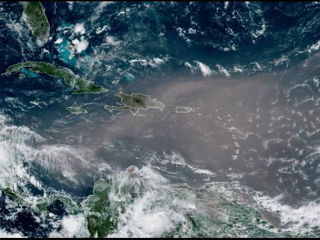 This satellite photo provided by the National Oceanic and Atmospheric Administration shows a cloud of dust coming from the Sahara Desert and arriving in the Caribbean on Monday, June 22. 