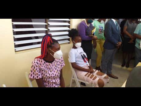 From left: Simone Pitter and one of the daughters of Suzette Pitter, who are among the recipients of three bedroom units in Annotto Bay, St Mary.  