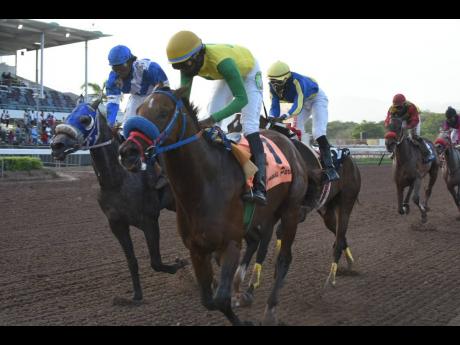 Credit: Kenyon Hemans
FATHER PATRICK (right), ridden by Omar Walker, holds off DUKE (Robert Halledeen) to claim victory in the 10th race at Caymanas Park yesterday.