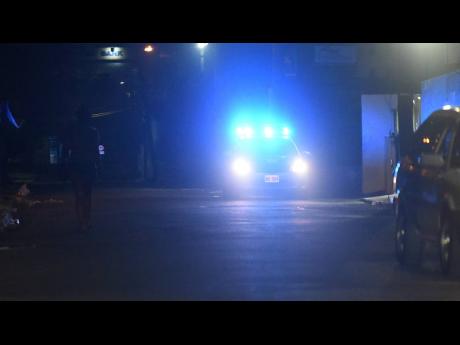 The flashing lights of a police service vehicle patrolling the Cross Roads red-light district indicate that business hours have ended for sex workers last Friday night.