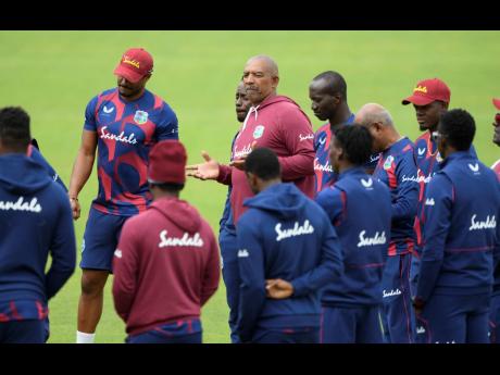 Credit: West Indies coach Phil Simmons (centre) speaks to his team members during a nets session at the Ageas Bowl in Southampton, England, yesterday. West Indies play their first Test match against England starting today.