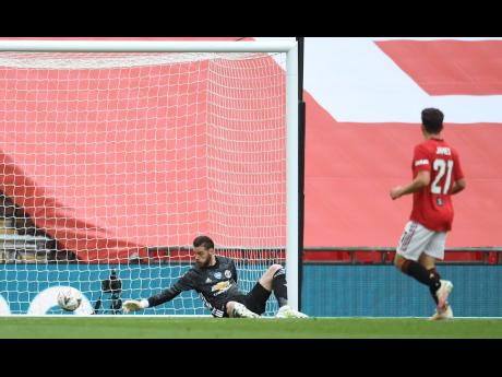 Manchester United goalkeeper David de Gea fails to stop the opening goal by Chelsea’s Olivier Giroud during their English FA Cup semi-final match at Wembley Stadium in London, England, yesterday.