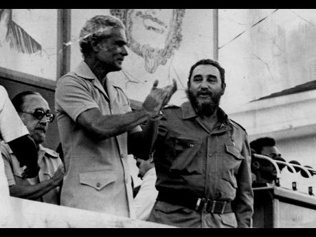 In this 1977 file photo Prime Minister Michael Manley applauds as Cuban President Dr Fidel Castro concluded his 90-minute address to the vast crowd which attend the Mass Rally at Sam Sharpe in Montego Bay.