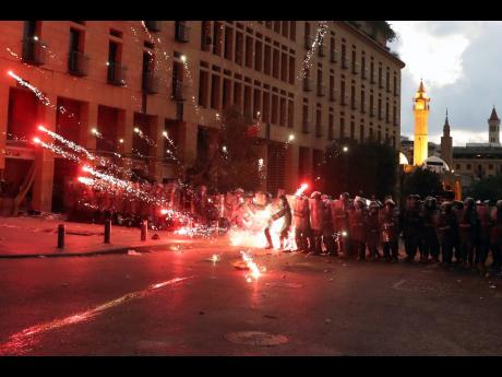 Credit: AP Anti-government protesters use fireworks against Lebanese riot police during a protest yesterday in the aftermath of last Tuesday’s massive explosion which devastated Beirut.
