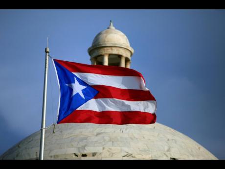 Credit: AP The Puerto Rican flag flies in front of Puerto Rico’s Capitol in San Juan.