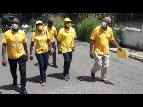 Independent candidate Peter Shand being accompanied to the nomination centre on Tuesday to file papers to contest the St Ann North Western seat on September 3.