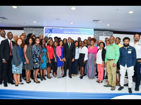 Credit: Contributed Floyd Green, minister of state in the Ministry of Industry, Commerce, Agriculture and Fisheries (centre), is flanked by representatives from the selected companies for the Export Max III export development programme. The announcement was made on December 1
