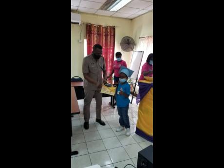 Credit: Contributed Superintendent Vernon Ellis presents one of the Salt Spring campers with a certificate of participation.