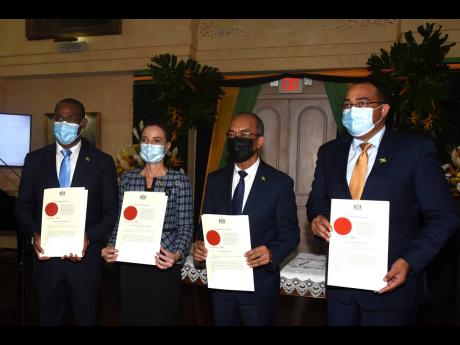 The  newly appointed ministers (from left), Nigel Clarke, minister of finance and the public service; Kamina Johnson Smith, minister of foreign affairs and foreign trade; Horace Chang, minister of national security; and Dr Christopher Tufton, minister of h