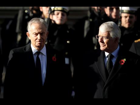 In this Sunday, November 10, 2019 file photo, former British Prime Ministers Tony Blair (left) and John Major attend the Remembrance Sunday ceremony at the Cenotaph in Whitehall in London. 