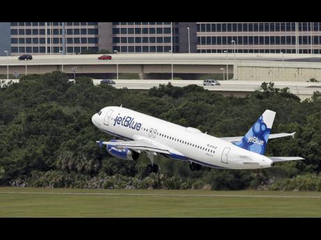 In this May 15, 2014 file photo, a JetBlue Airways Airbus A320-232 takes off from Tampa International Airport in Florida.  JetBlue is set to launch a major Caribbean expansion in November, with new routes across the region from Aruba to St Maarten.